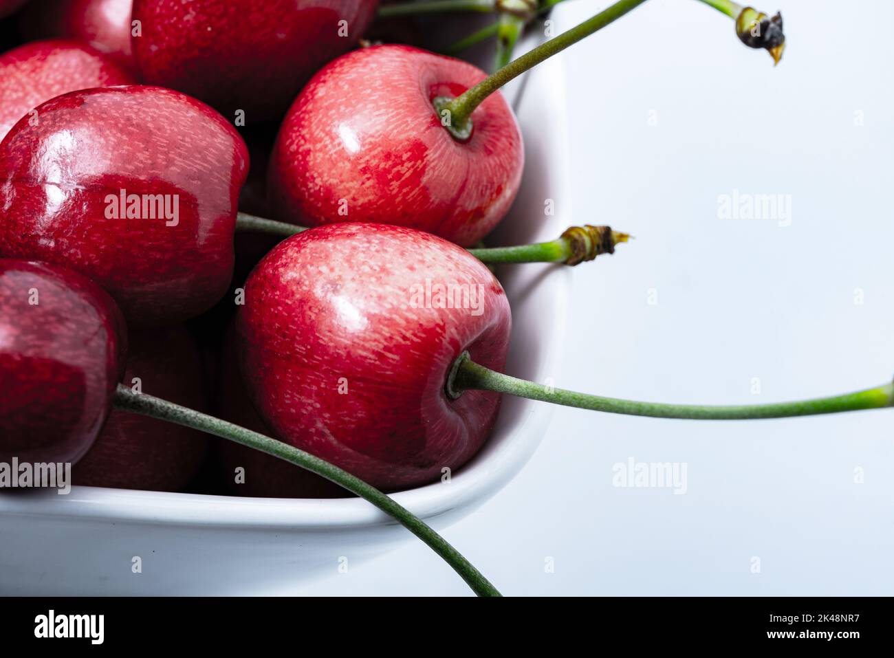 Cherries in closeup. Red fruit with green petioles. The structure of
