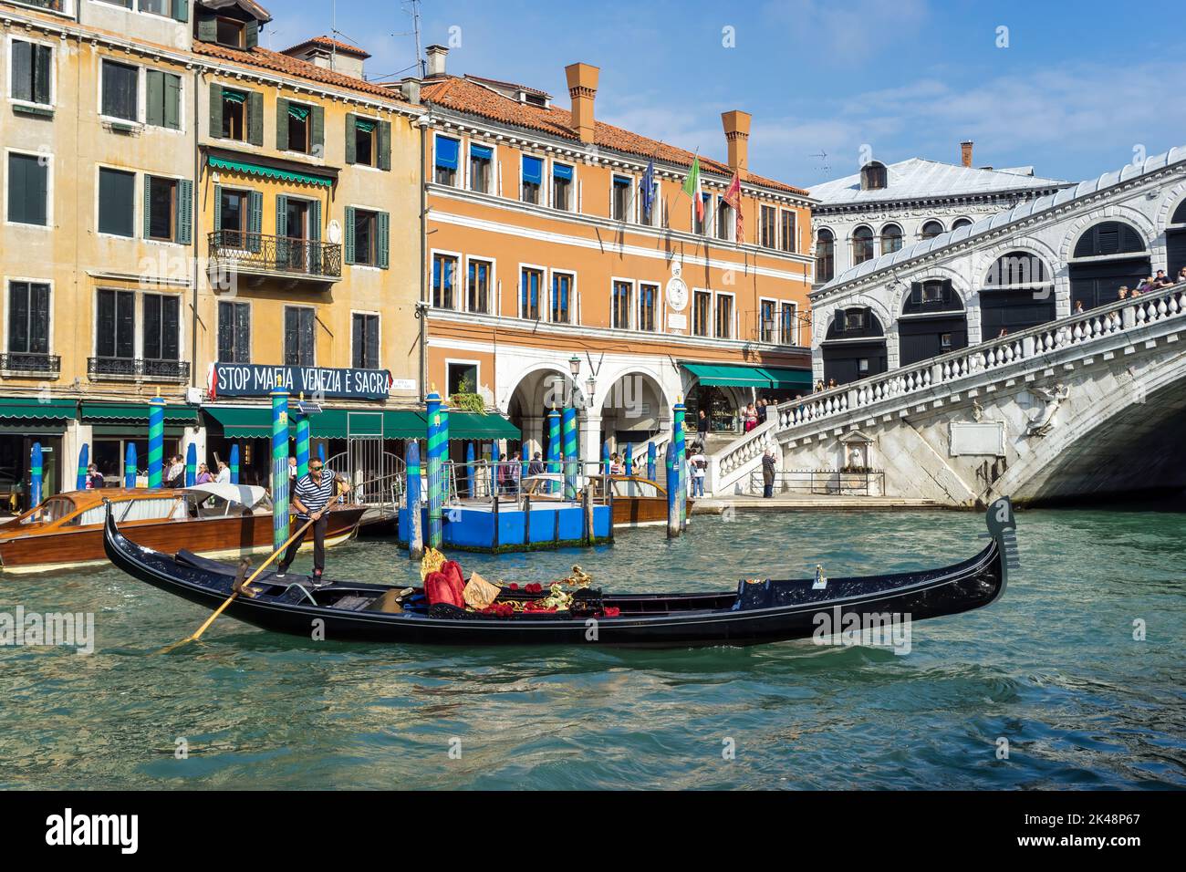 VENICE, ITALY - OCTOBER 12 : Gondolier in action in Venice on October 12, 2014. Unidentified people. Stock Photo