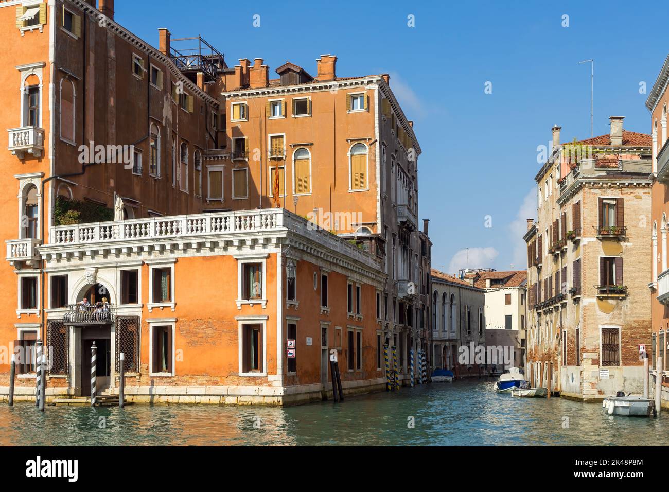 VENICE, ITALY - OCTOBER 12 : Colourful buildings along a canal in Venice on October 12, 2014. Two unidentified people. Stock Photo