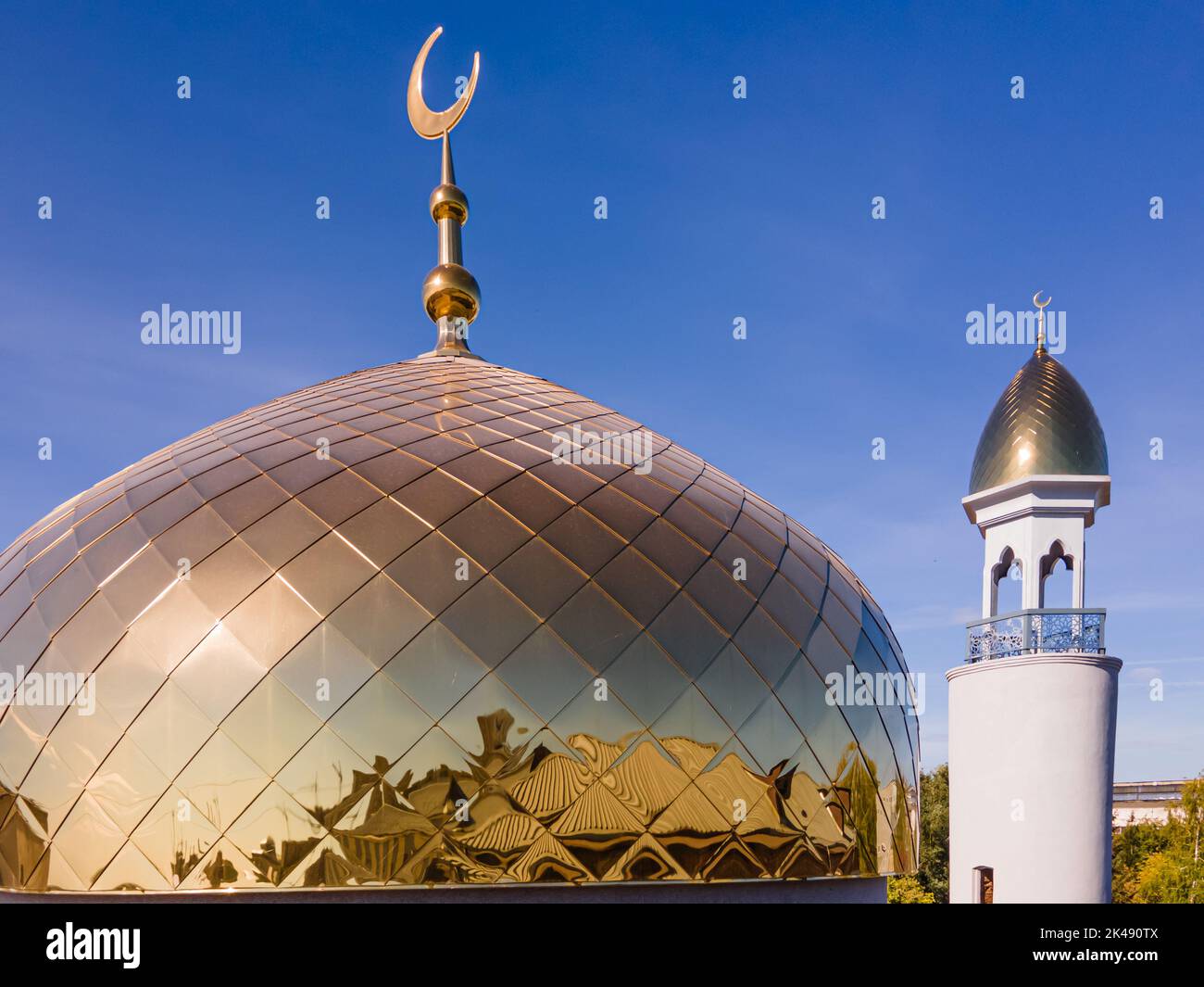 A Muslim golden dome with a crescent moon on the mosque. Minaret against the sky. Arab day. Islamic symbols of religion. Faith in Allah. Crescent moon Stock Photo