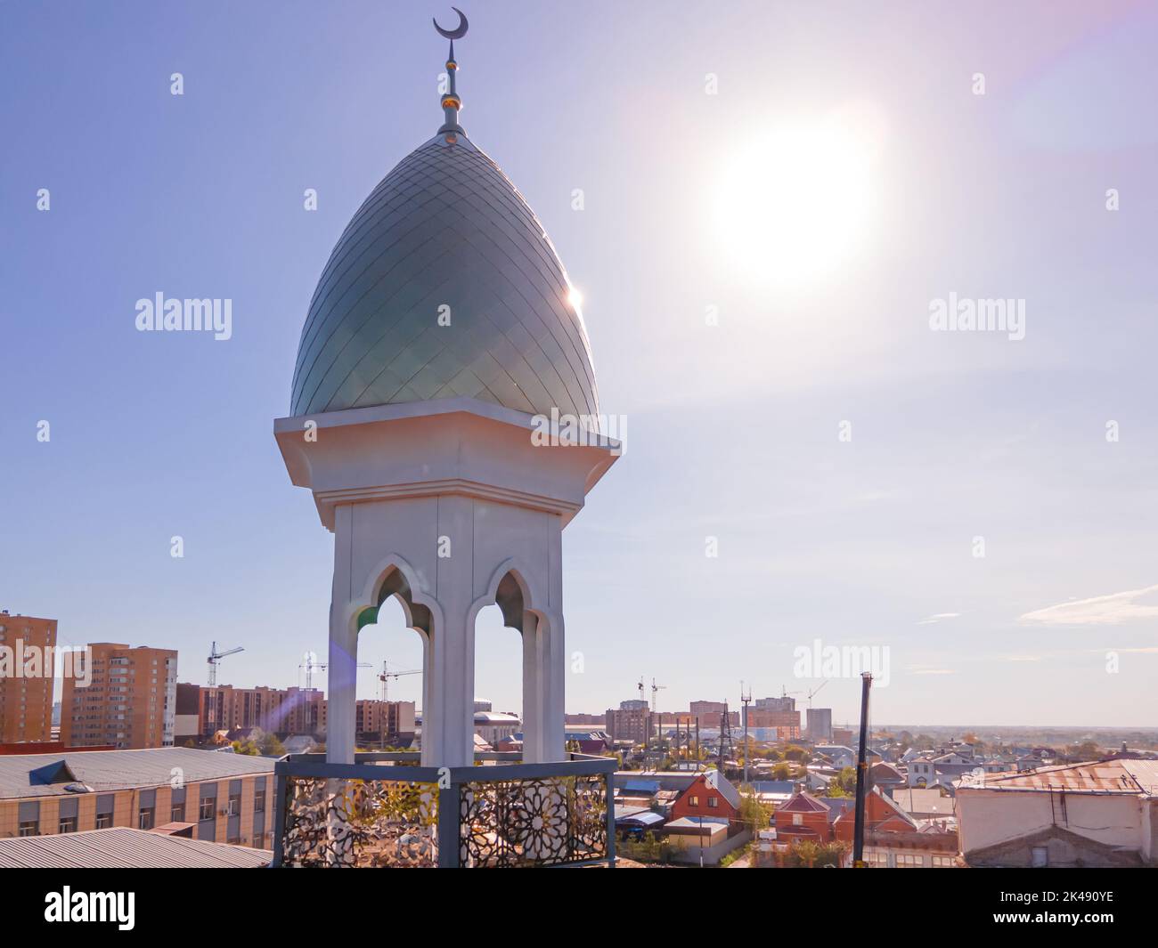A Muslim golden dome with a crescent moon on the mosque. Minaret against the sky. Arab day. Islamic symbols of religion. Faith in Allah. Crescent moon Stock Photo