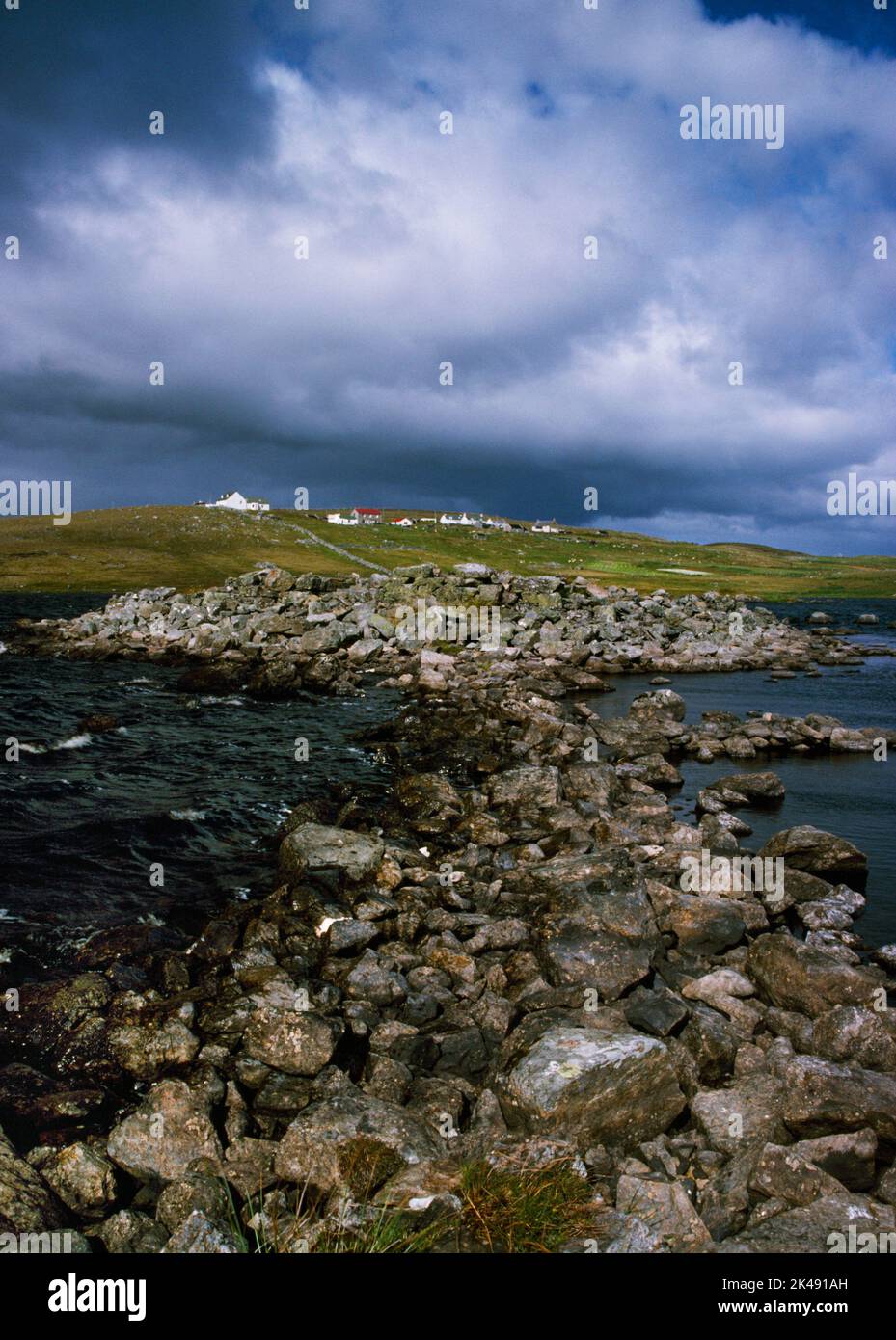 View NE of the Iron Age ring fort, blockhouse & manmade causeway linked to the S shore of the Loch of Huxter, Whalsay, Shetland, Scotland, UK. Stock Photo