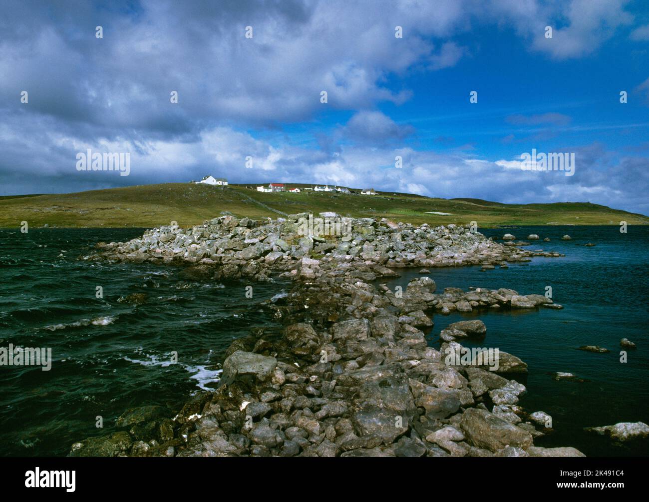 View NE of the Iron Age ring fort, blockhouse & manmade causeway linked to the S shore of the Loch of Huxter, Whalsay, Shetland, Scotland, UK. Stock Photo