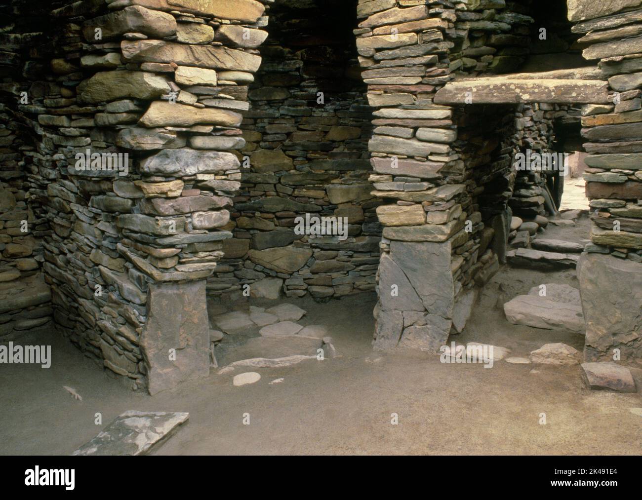 View WNW inside Iron Age Wheelhouse II at Jarlshof settlement, Sumburgh, Shetland, Scotland, UK, showing radial piers, compartments & a stone tank. Stock Photo