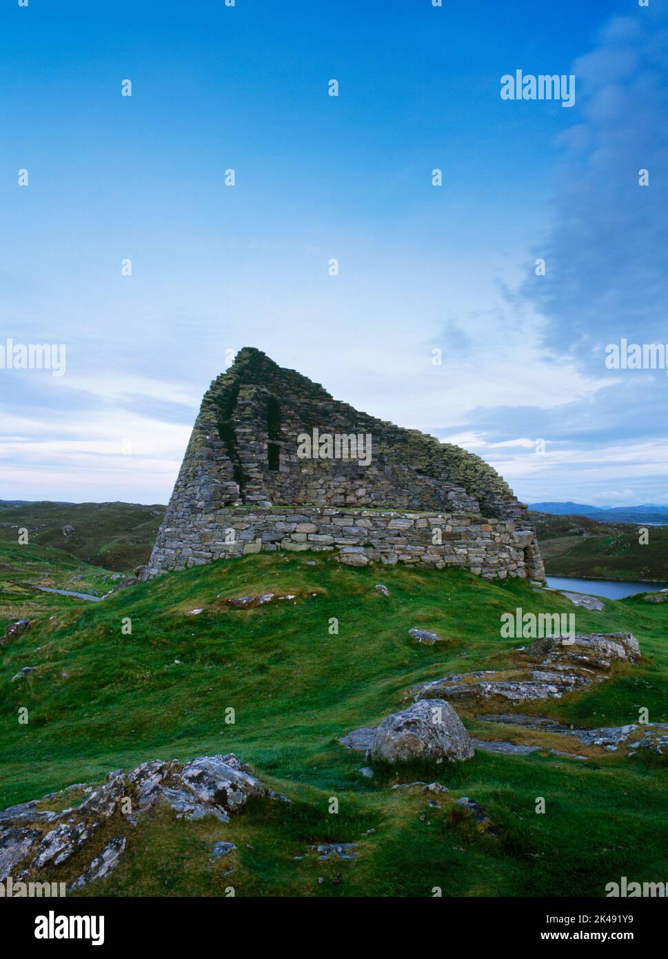 View SSW of Dun Carloway Iron Age broch, Isle of Lewis, Scotland, UK, showing entrance (R) & the inner & outer drystone walls containing a staircase. Stock Photo