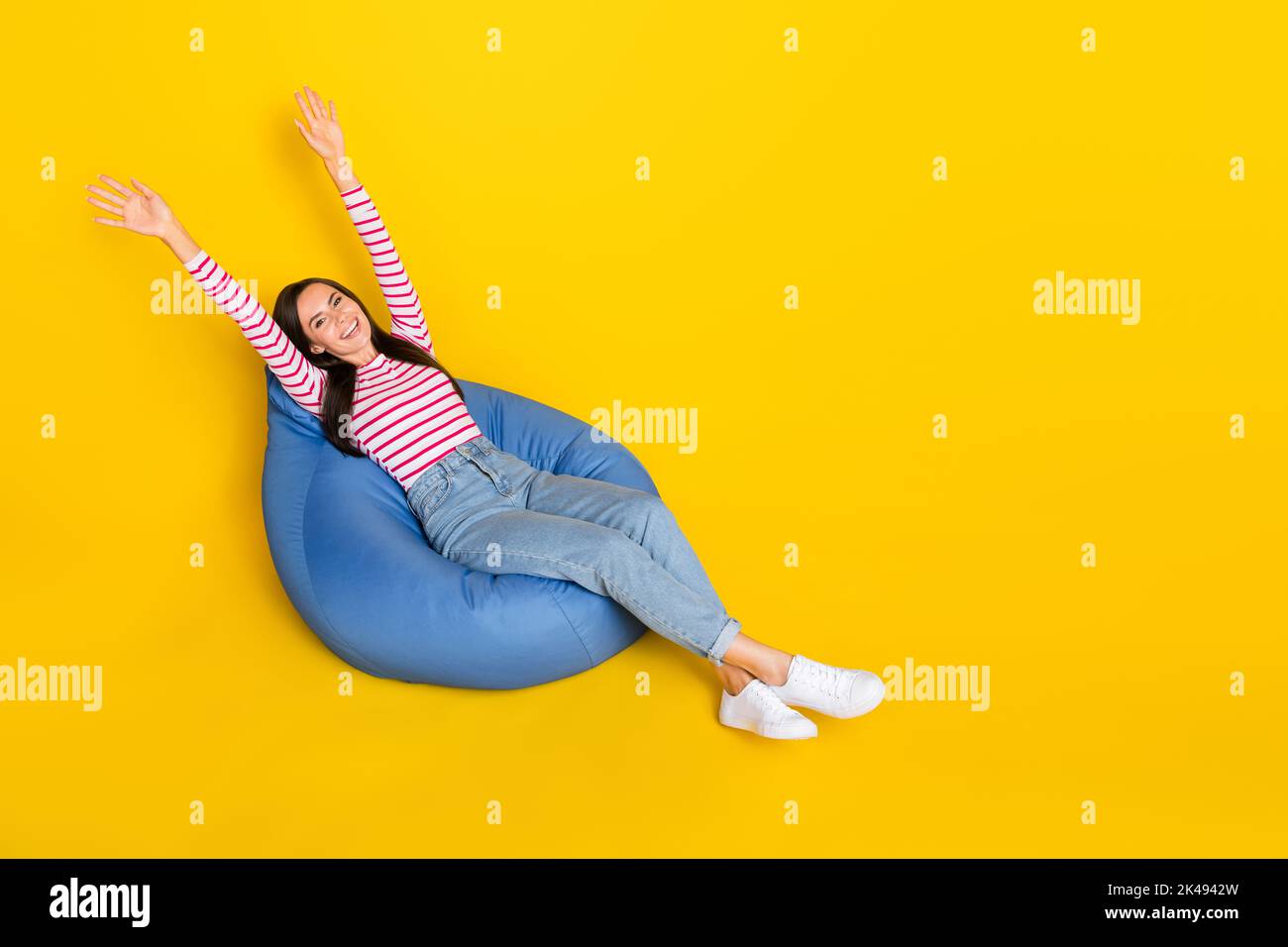 Full size photo of optimistic woman wear striped top jeans sit