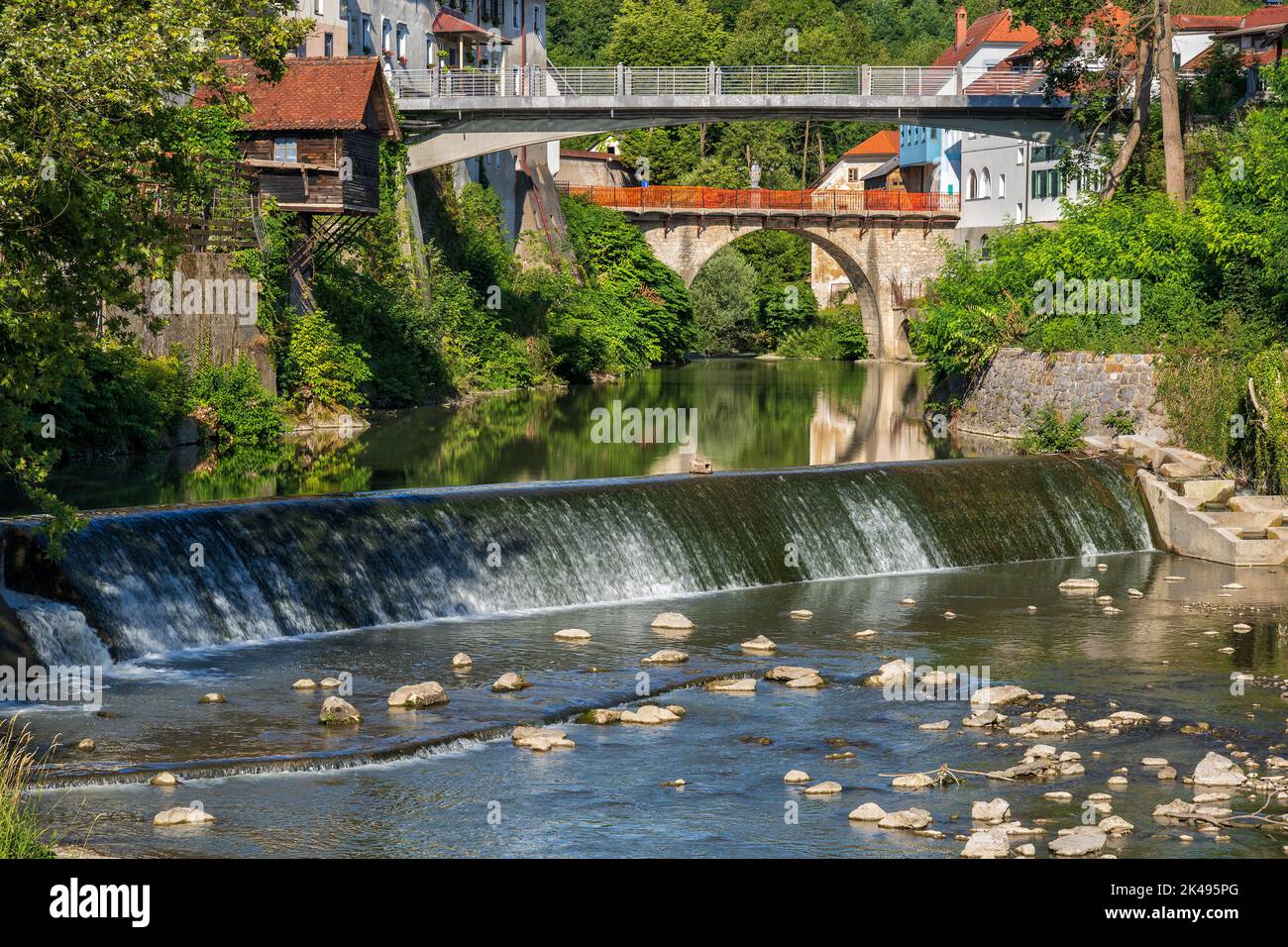 Selska Sora river with water cascade and bridges in Skofja Loka town in ...