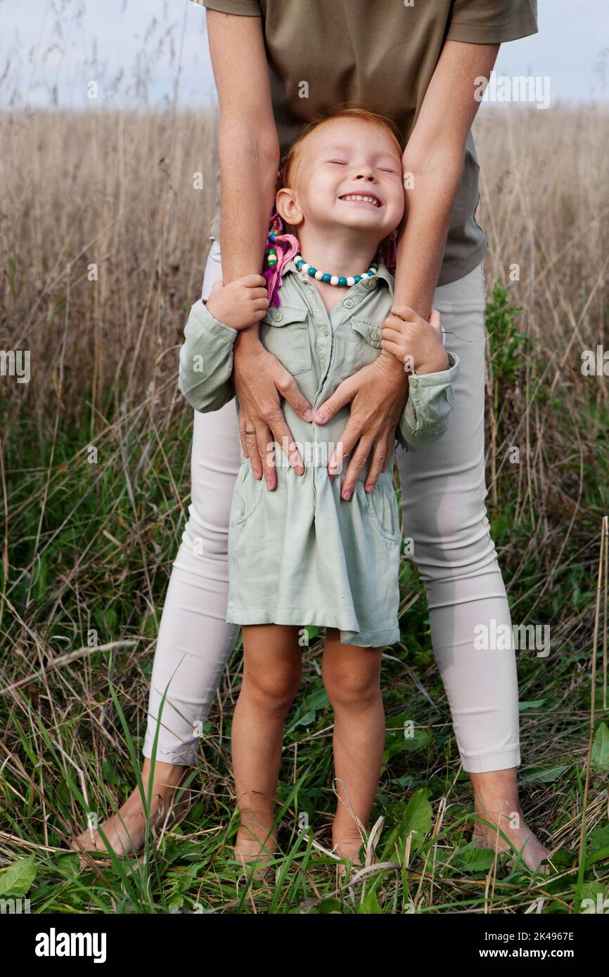 Happy Smiling Girl Laughs And Closed Eyes In Grass In Summer Nature