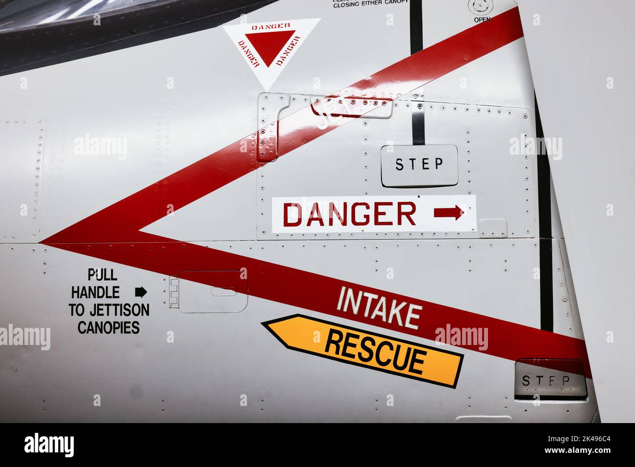 Danger aircraft jet ejector seat rescue and intake signs on side of modern military airforce plane. Stock Photo