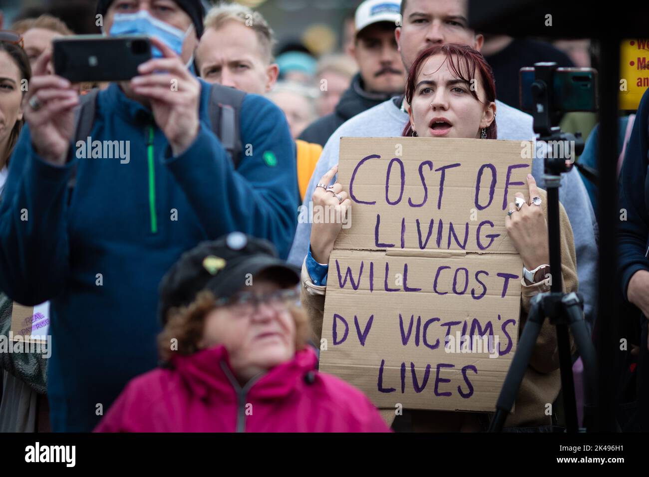 Manchester, UK. 01st Oct, 2022. A protester with a placard watches the speeches from the Enough is Enough and Don't Pay campaign groups. The movements want to see the government deal with the cost of living crisis by slashing energy bills and increasing salaries to help people deal with inflation. Credit: Andy Barton/Alamy Live News Stock Photo