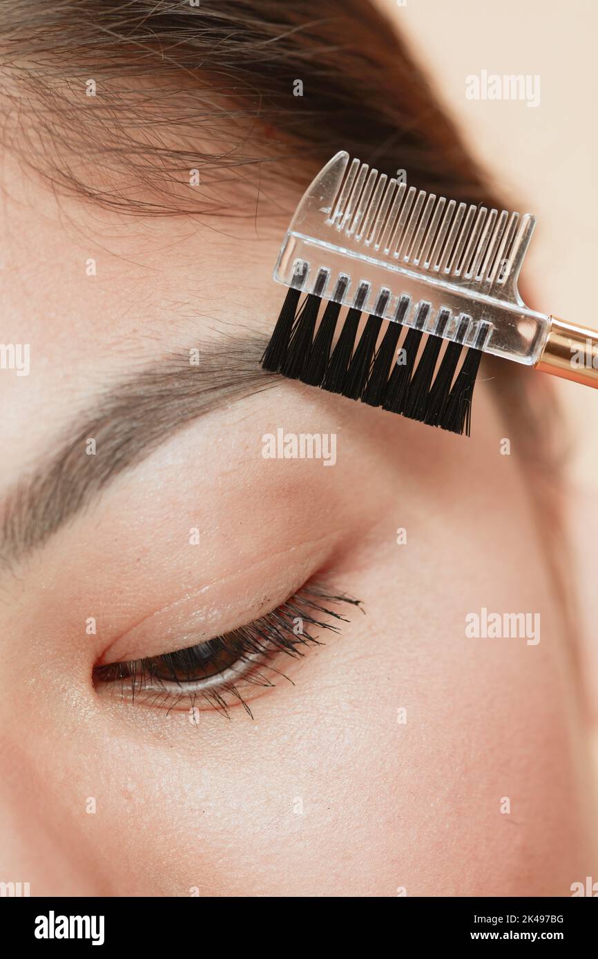 Closeup on woman with brow brush. Stock Photo