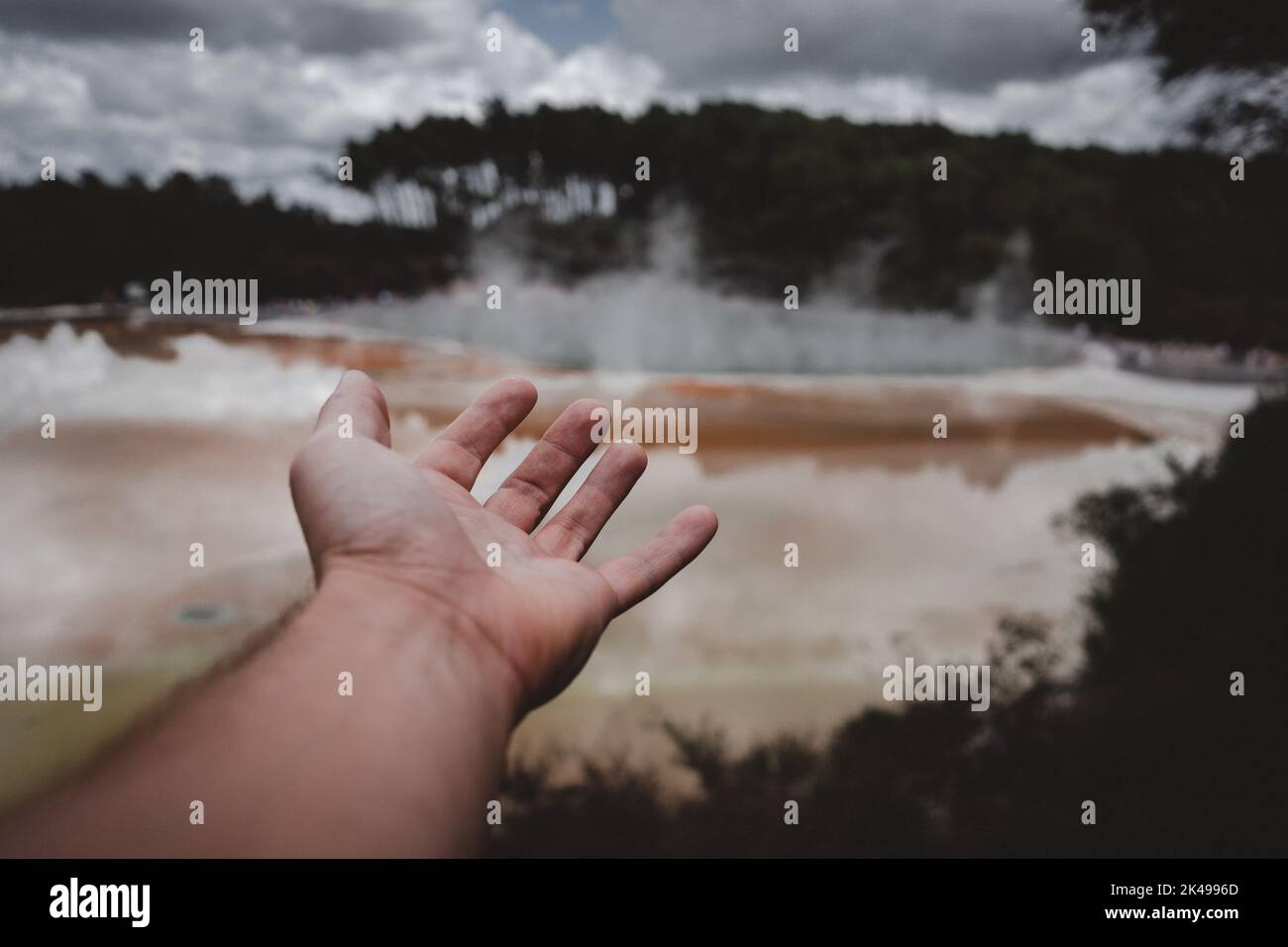 hand and arm pointing to the lake in rotorua Stock Photo