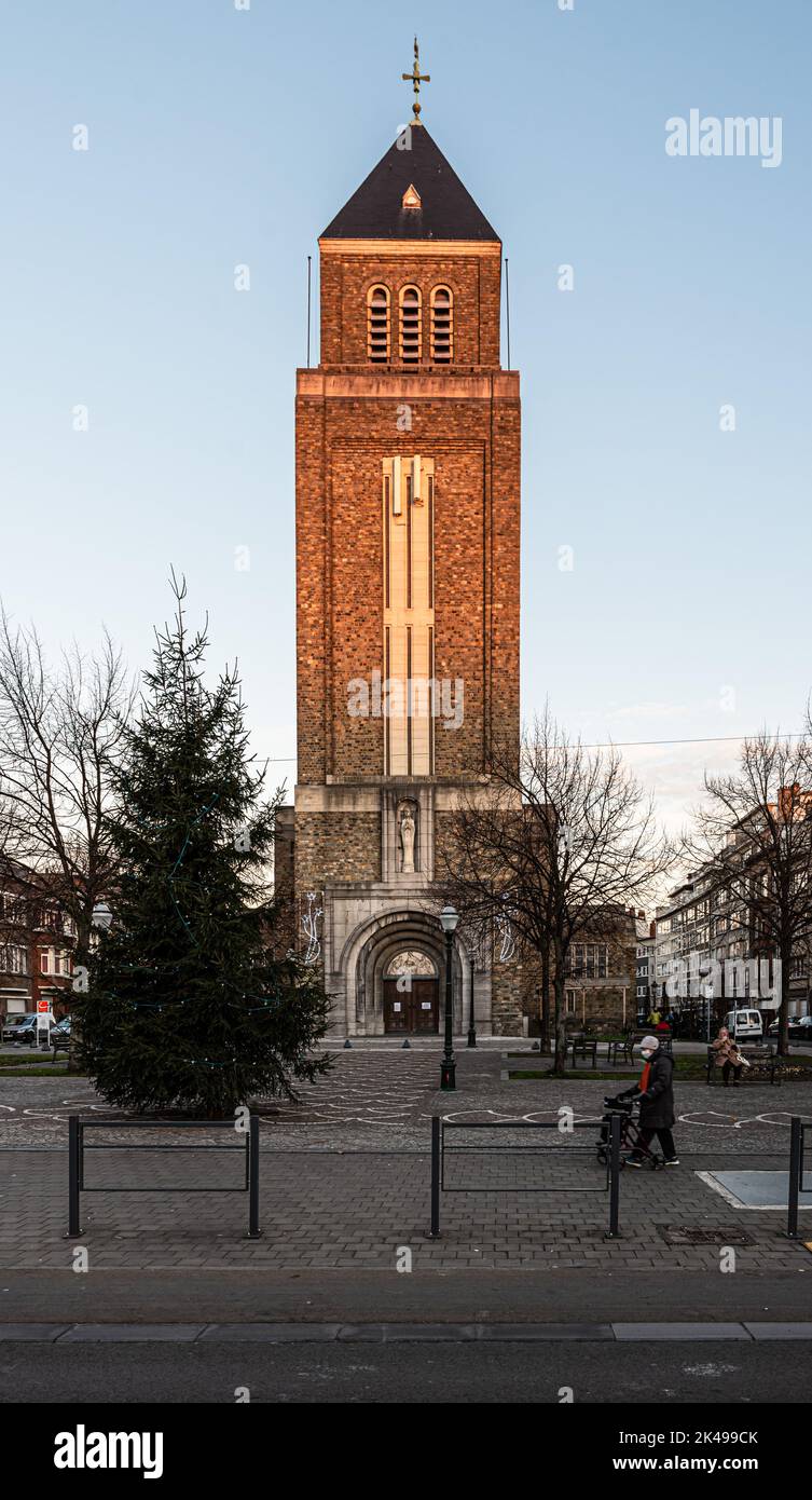 Jette, Brussels Capital Region, Belgium, 12 20 2020 - Our Lady of Lourdes church and rectangular tower at sunset Stock Photo