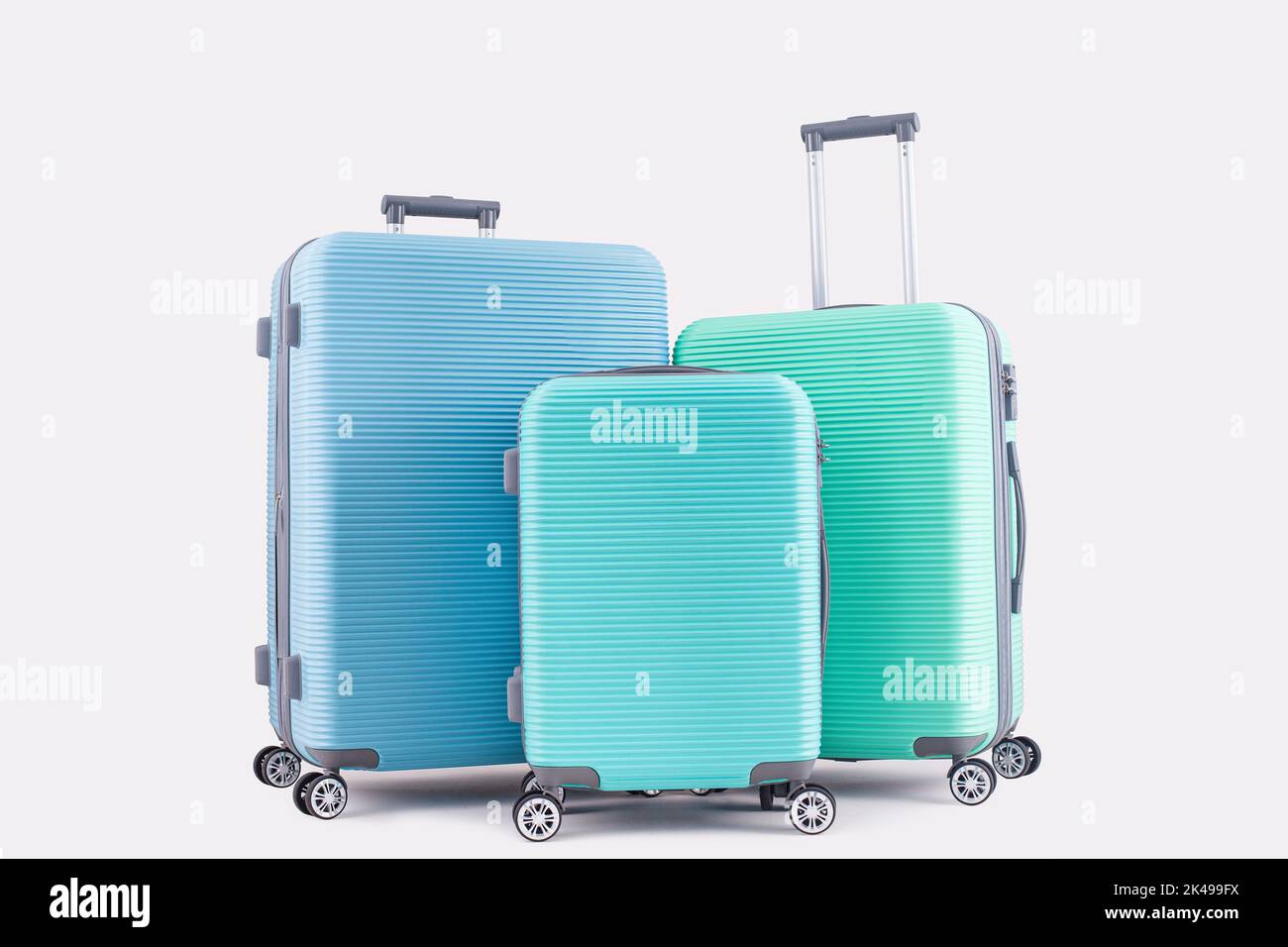 Blue Mint Green suitcase isolated on pastel background vacation luggage Stock Photo