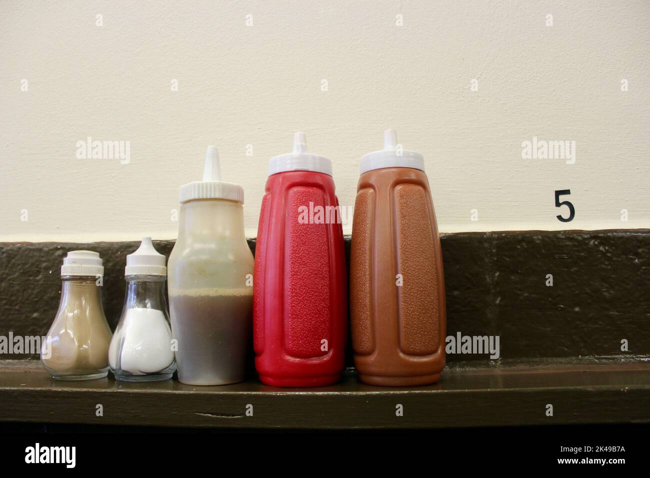 condiment selection of ketchup pepper salt vinegar and brown sauce at