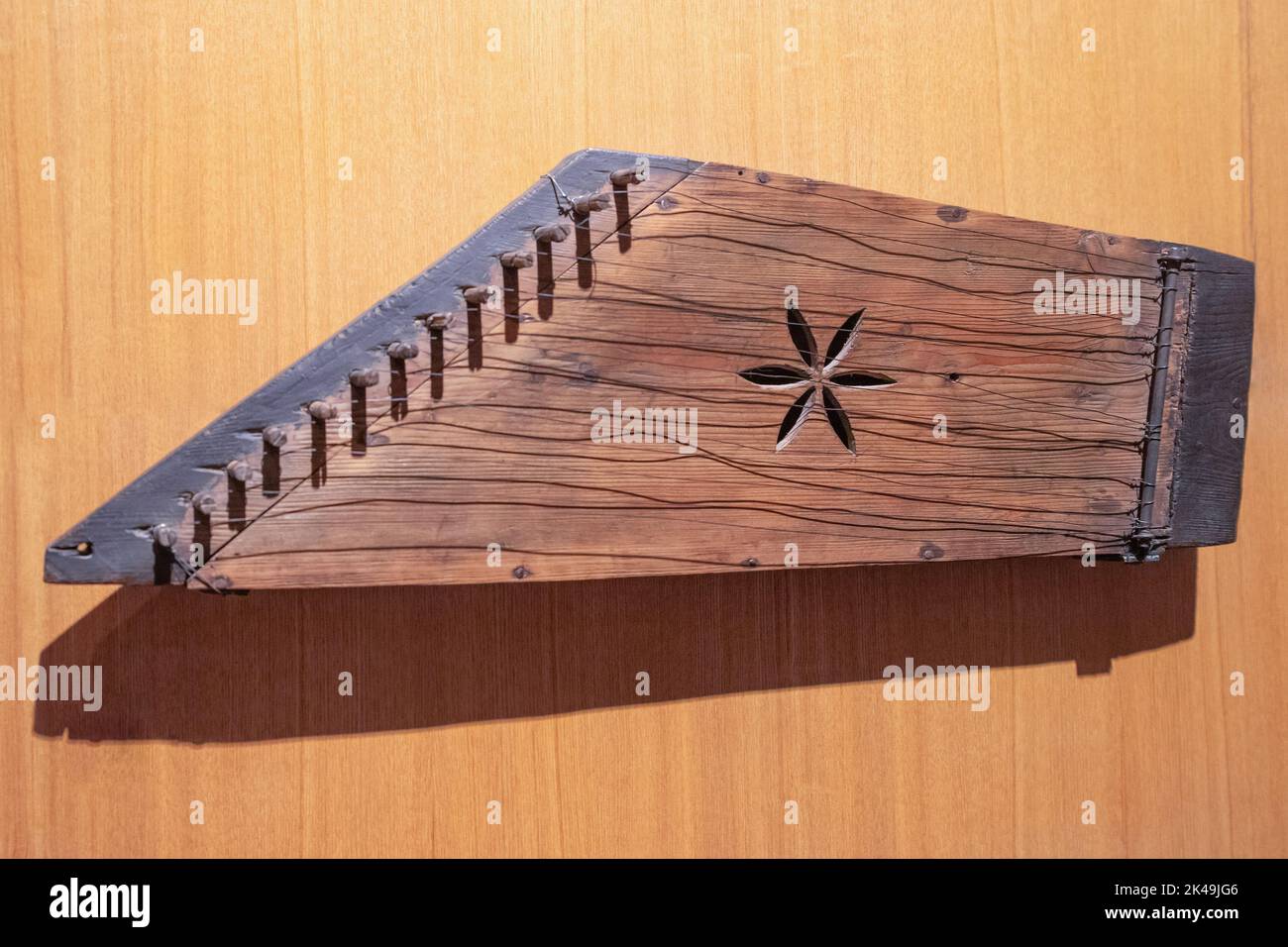 Wooden Gusli on wood background. Ancient East Slavic stringed plucked