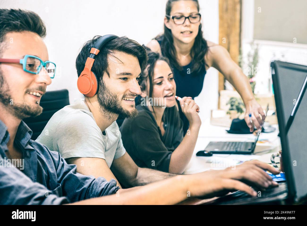 Group of young people employee workers with computer in startup studio - Human resource business and teamwork concept on laptop working time - Start u Stock Photo