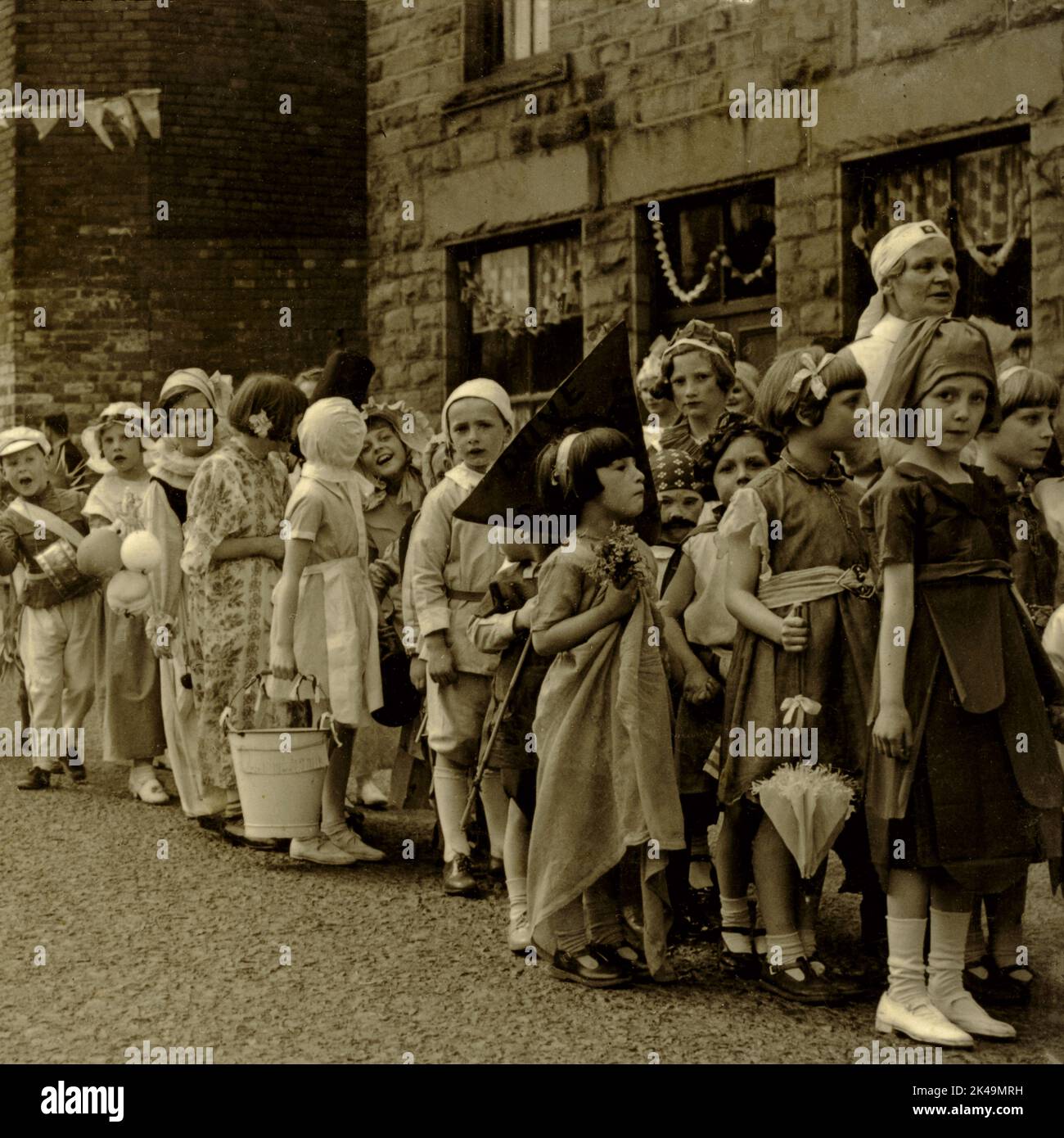 Chattering children in homemade fancy dress wait, probably in Wakefield