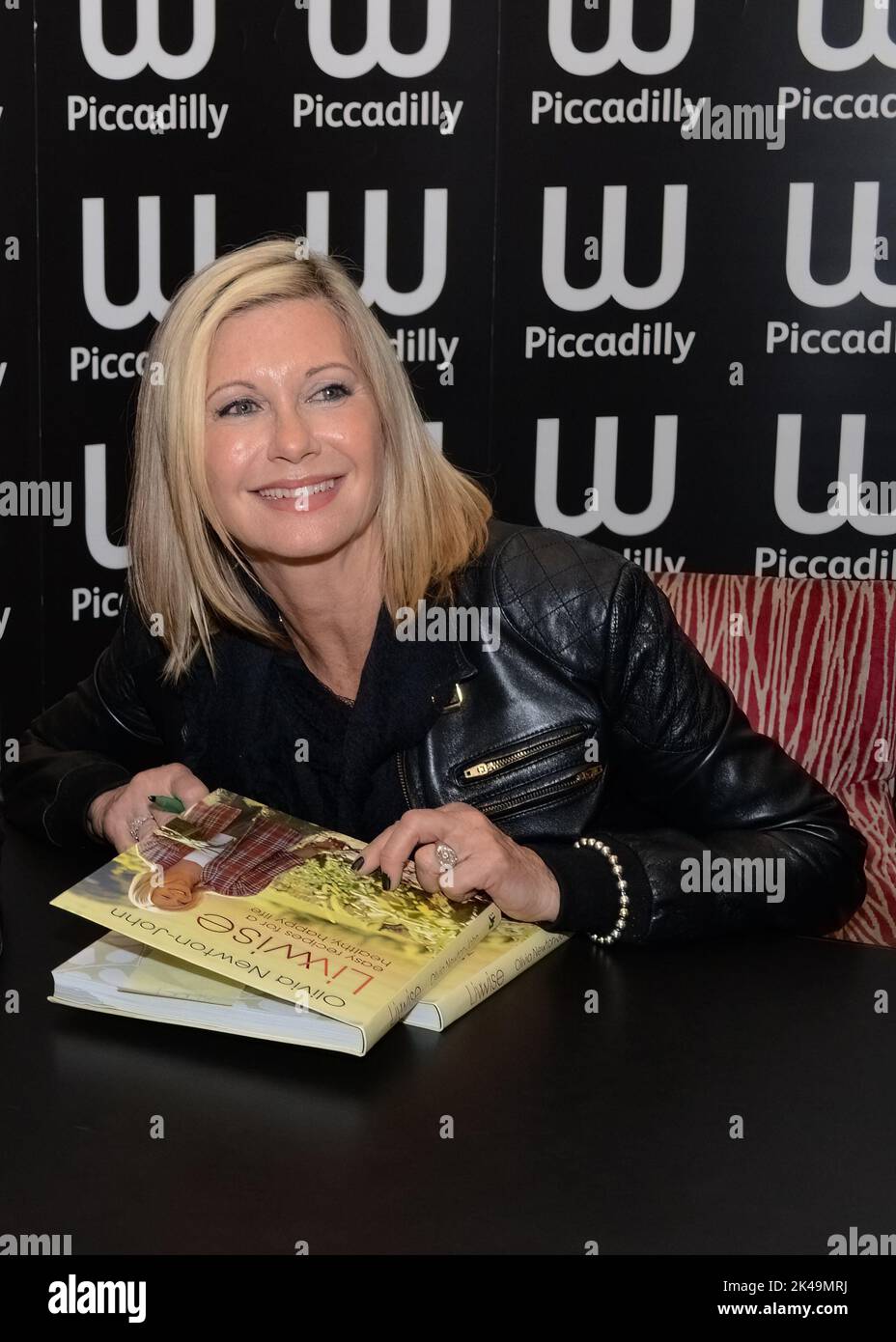 Olivia Newton-John signs copies of her book 'LivWise: Easy Recipes for a Healthy Happy Life' at Waterstones Piccadilly in London on April 19, 20212 Stock Photo
