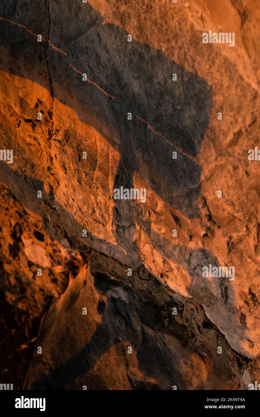 shadow of a two bench seat on a rock wall Stock Photo