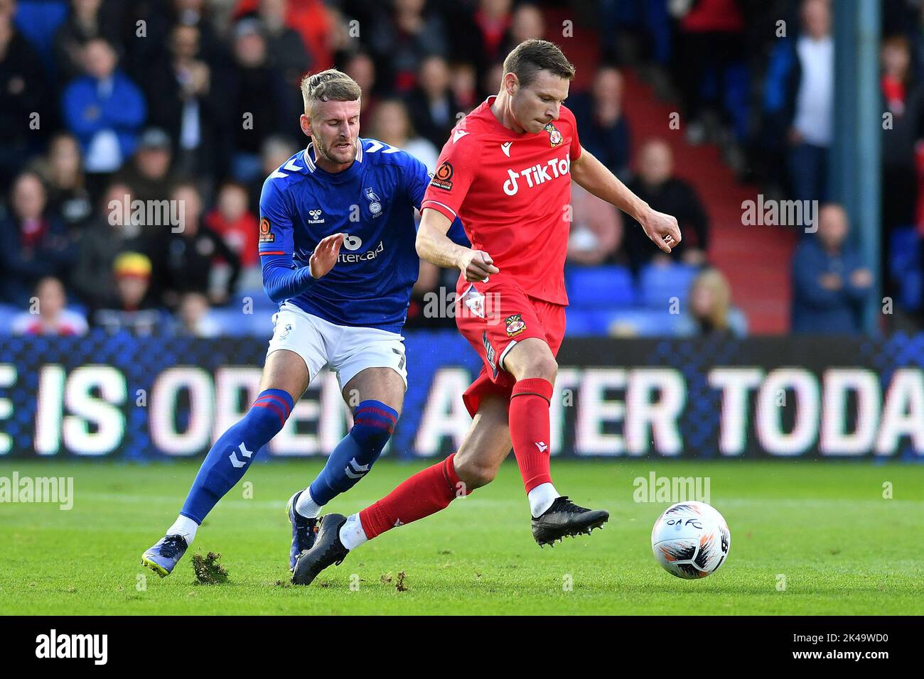 Oldham, UK. 1st October 2022during the Vanarama National League match between Oldham Athletic and Wrexham at Boundary Park, Oldham on Saturday 1st October 2022Jack Stobbs of Oldham Athletic tussles with Paul Mullin of Wrexham Football Club during the Vanarama National League match between Oldham Athletic and Wrexham at Boundary Park, Oldham on Saturday 1st October 2022. Credit: MI News & Sport /Alamy Live News Stock Photo