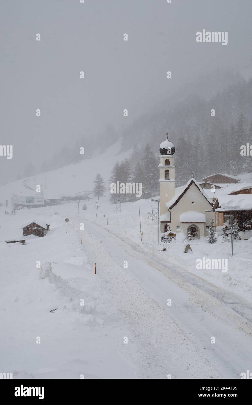 A vertical shot of a heavy snow-covered road in Obergurgl village, Austria Stock Photo