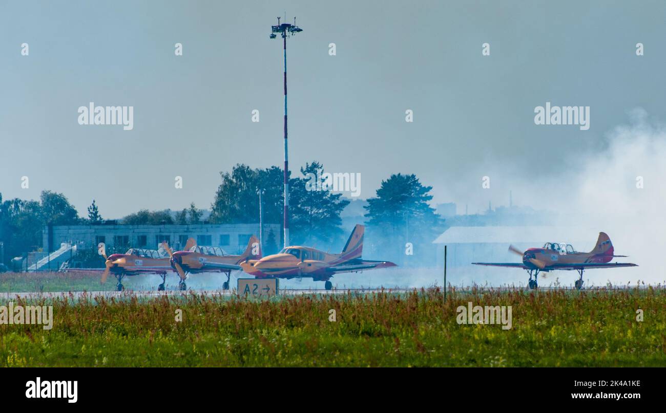 August 30, 2019, Moscow region, Russia. Training aircraft Yak-52 and Piper PA-23 of the aerobatic group 'First Flight' on the runway of the airfield. Stock Photo