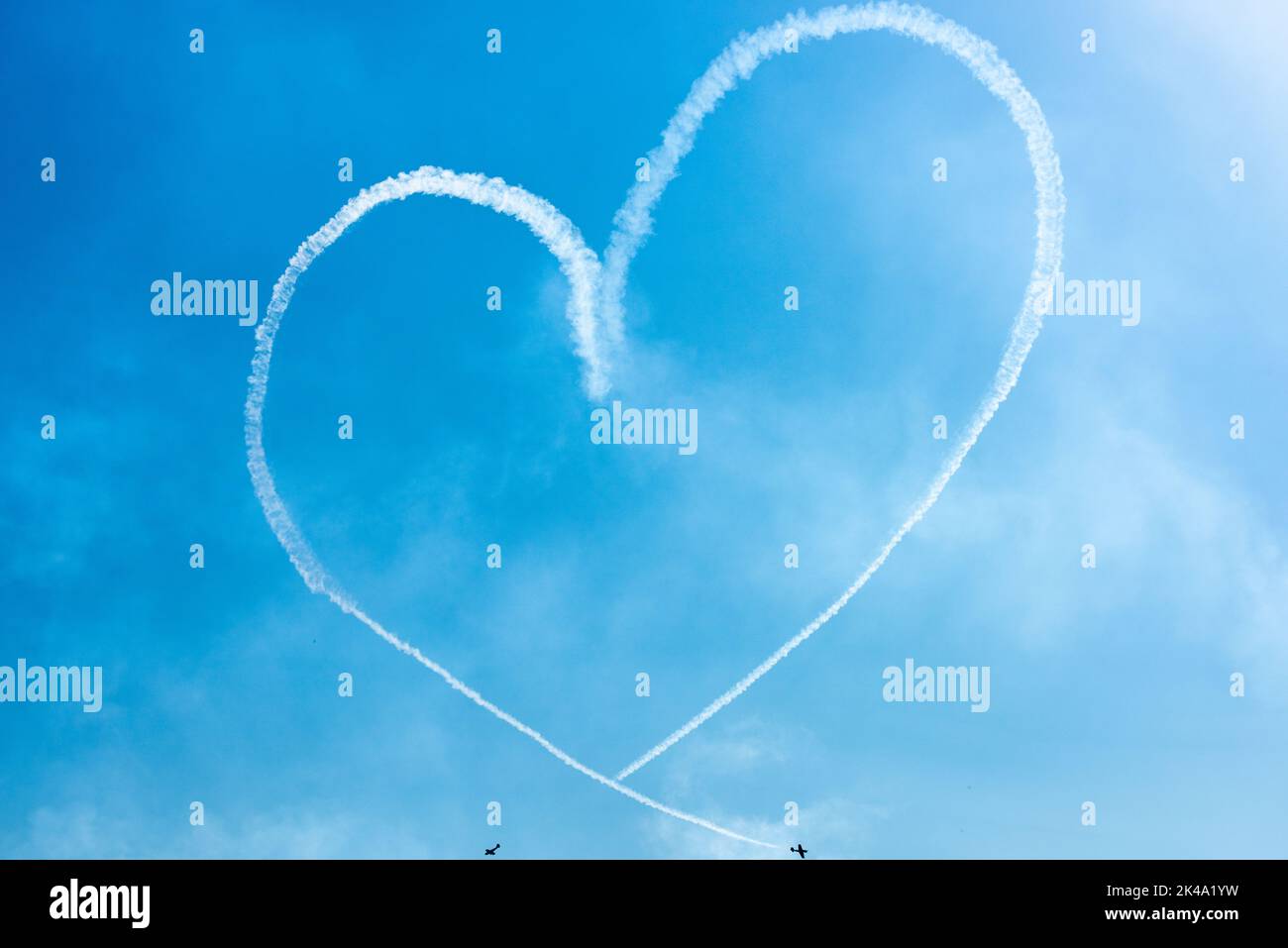 Two Light Airplanes In The Sky Writing Romantic Heart Shape Stock Photo
