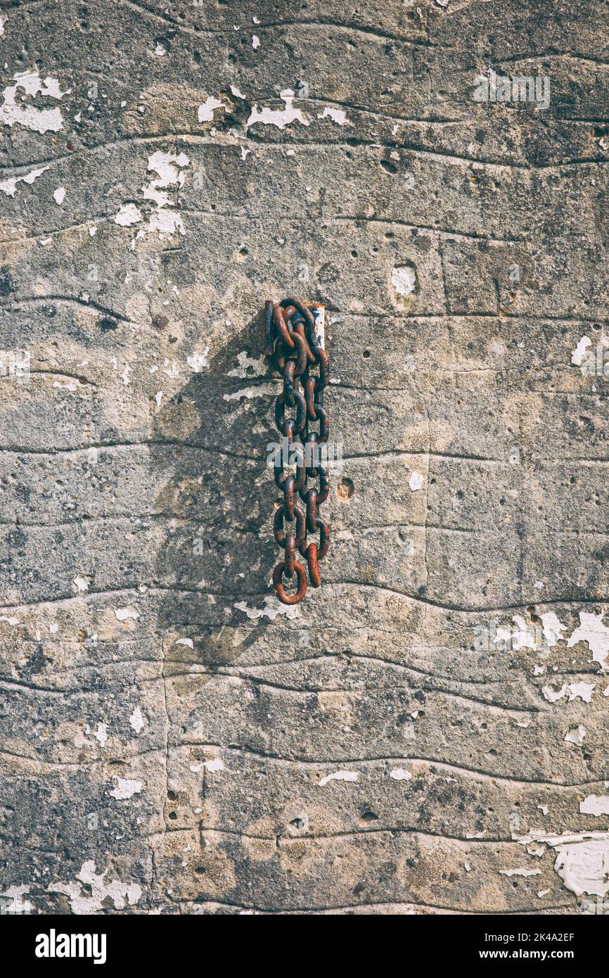 Rusty old chain hanging against a wall Stock Photo Alamy
