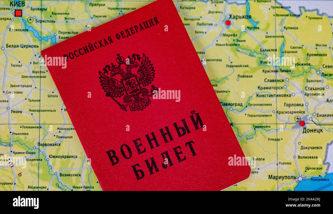 September 25, 2022, Moscow, Russia. Military ticket of a reserve serviceman of the Russian Federation on the background of a map of Ukraine Stock Photo