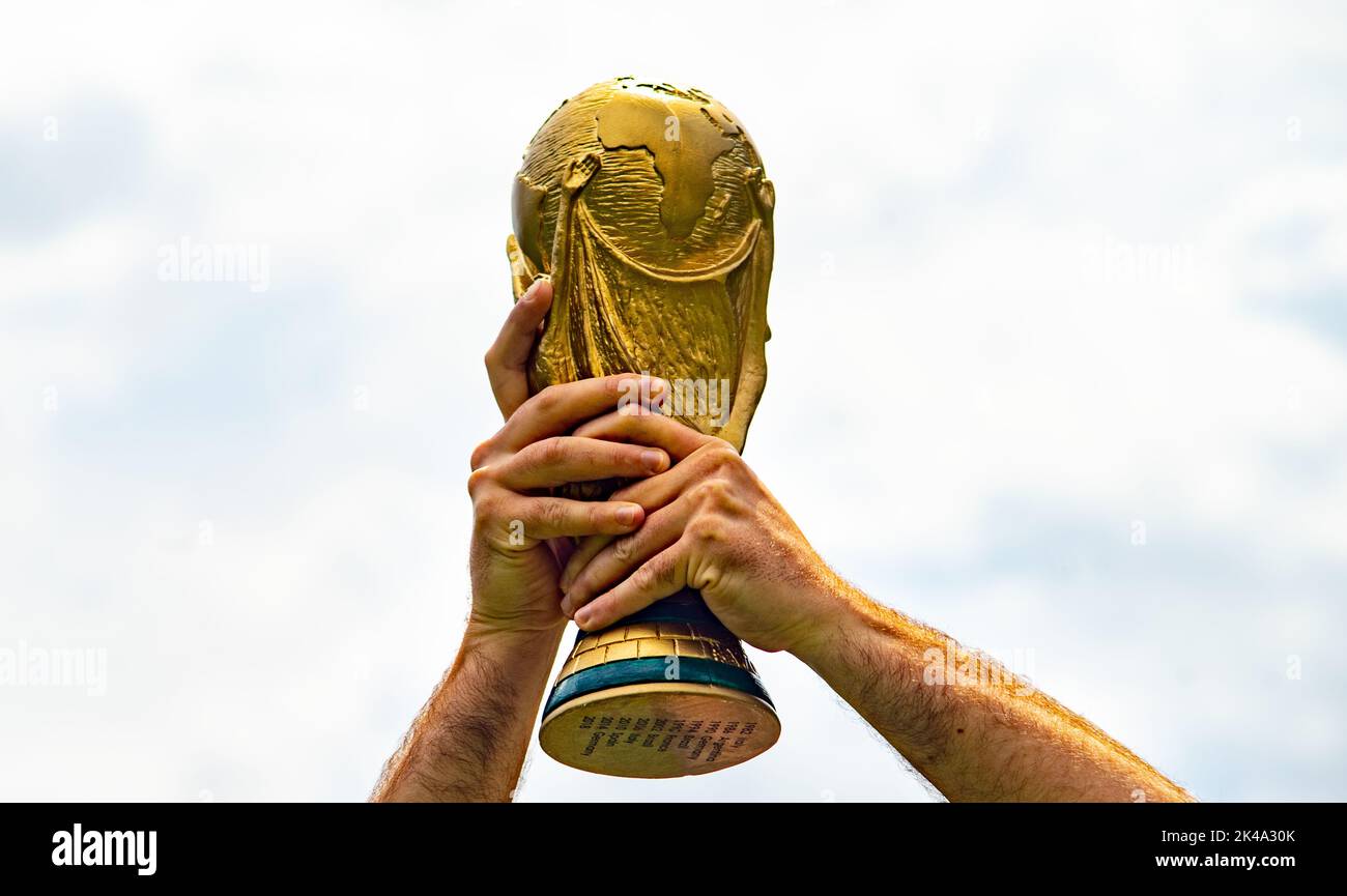 June 12, 2018, Doha, Qatar, A man holds the FIFA World Cup in his hands. Stock Photo
