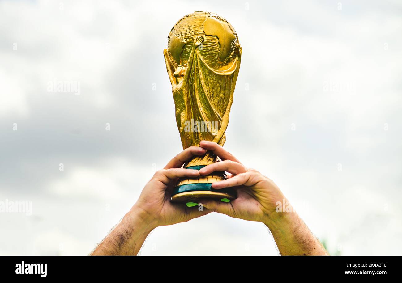 June 12, 2018, Doha, Qatar, A man holds the FIFA World Cup in his hands. Stock Photo