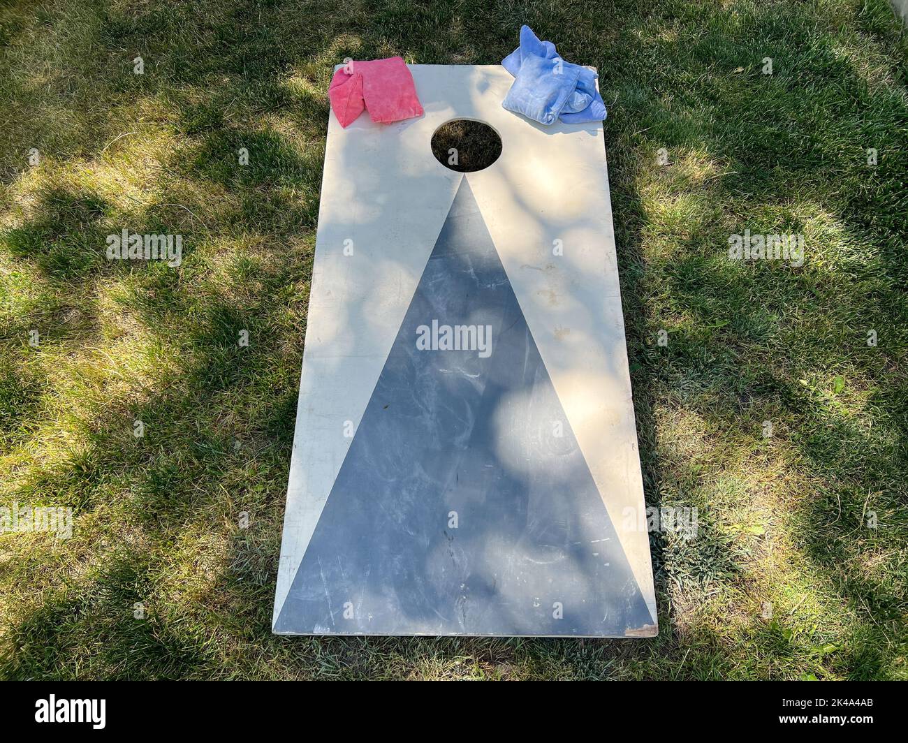 A cornhole yard game board and bean bags Stock Photo Alamy