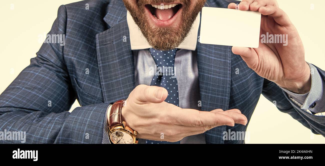 just look over there. businessman presenting credit or debit card. happy ceo. Horizontal poster design. Web banner header, copy space. Stock Photo