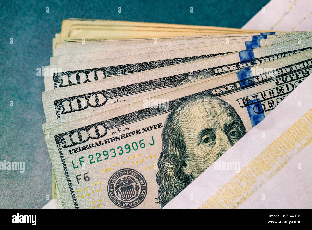 One Hundred USD Dollar Bills in an envelope Stock Photo