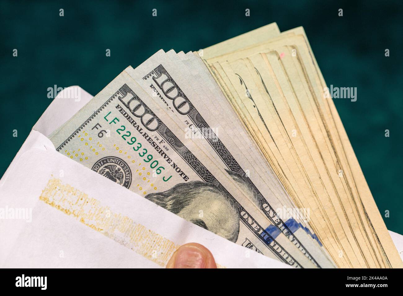 One Hundred USD Dollar Bills in an envelope Stock Photo