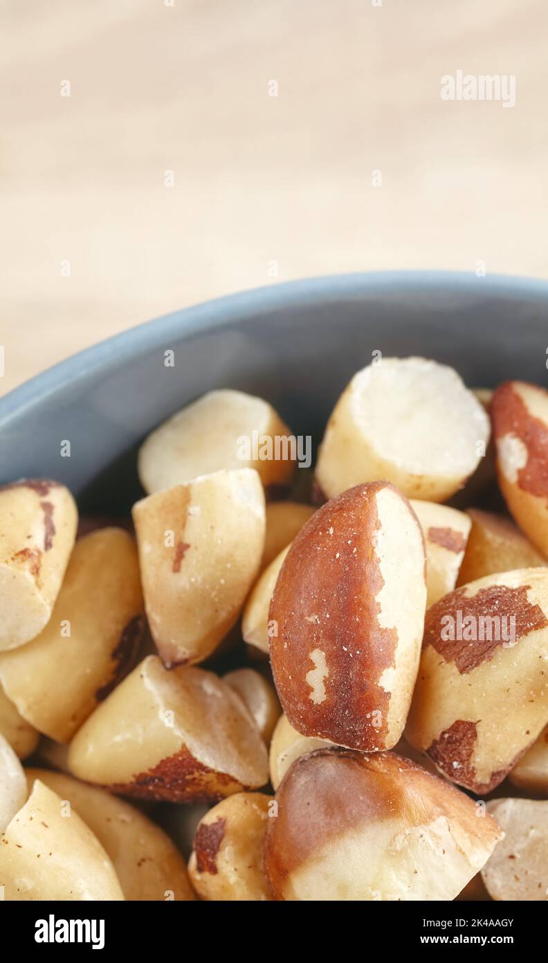 Close up picture of brazil nuts in a bowl, selective focus. Stock Photo