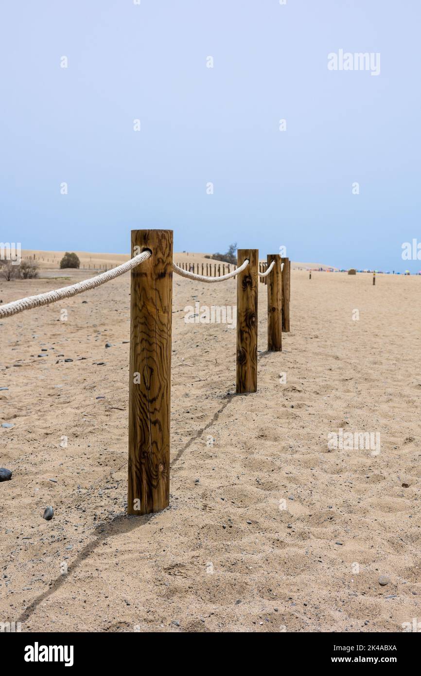 A log fence in a sandy shore on a sunny morning Stock Photo - Alamy