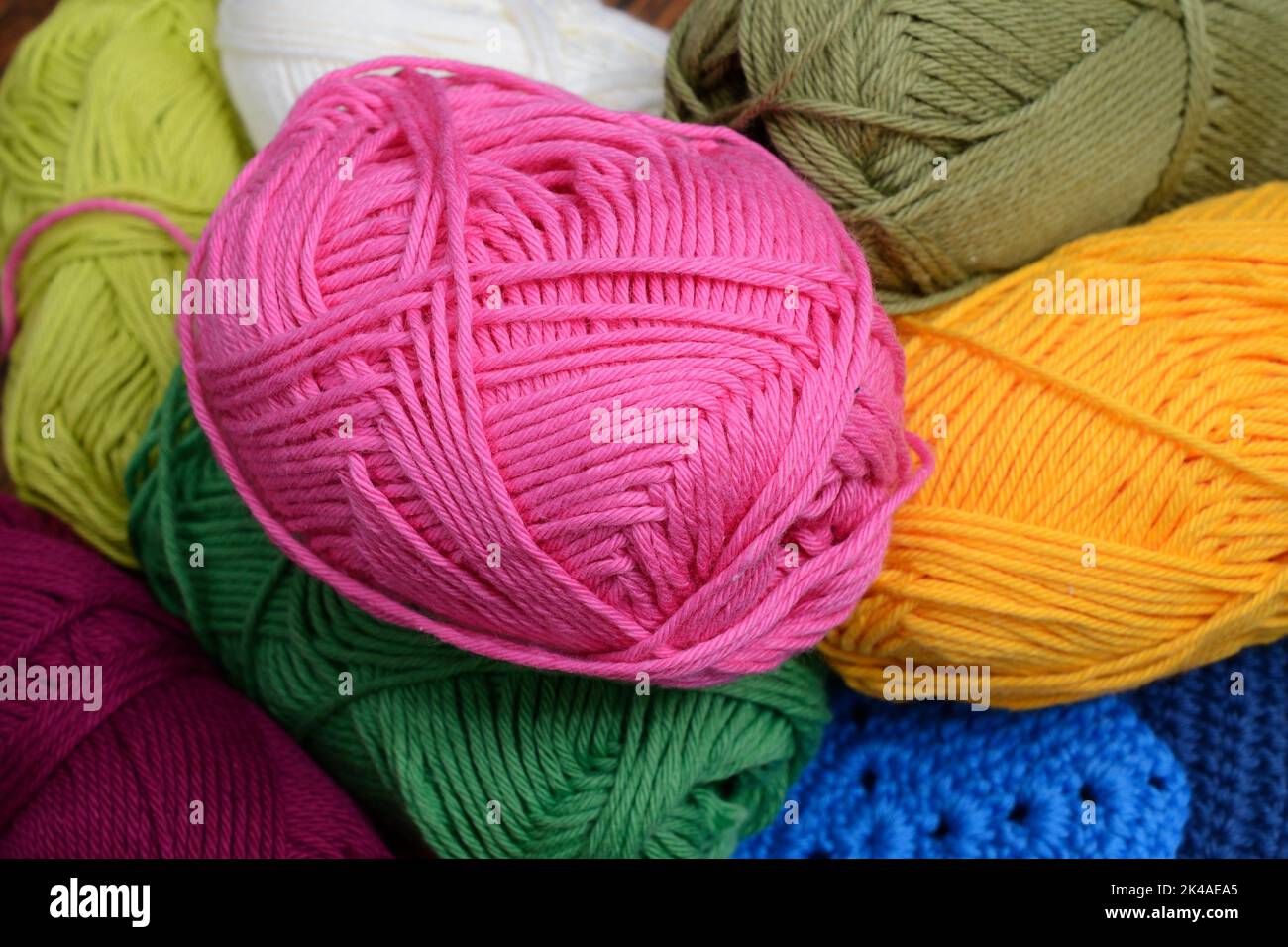 colorful skeins of wool, pink yellow and green Stock Photo