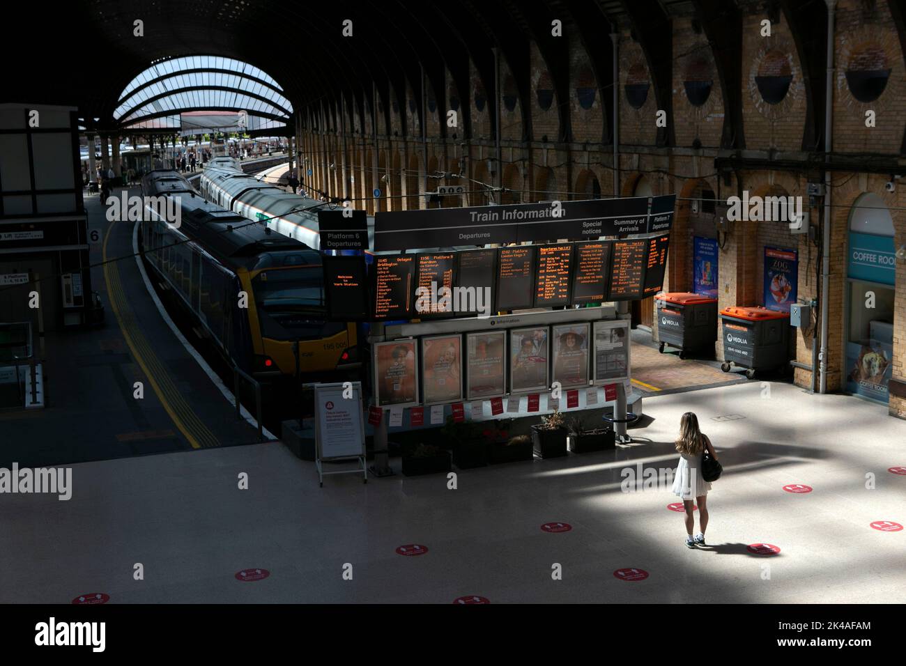 A lone Rail passenger waits for a train at York train station in North Yorkshire as the UK rail strikes continues in June 2022 throughout the country Stock Photo