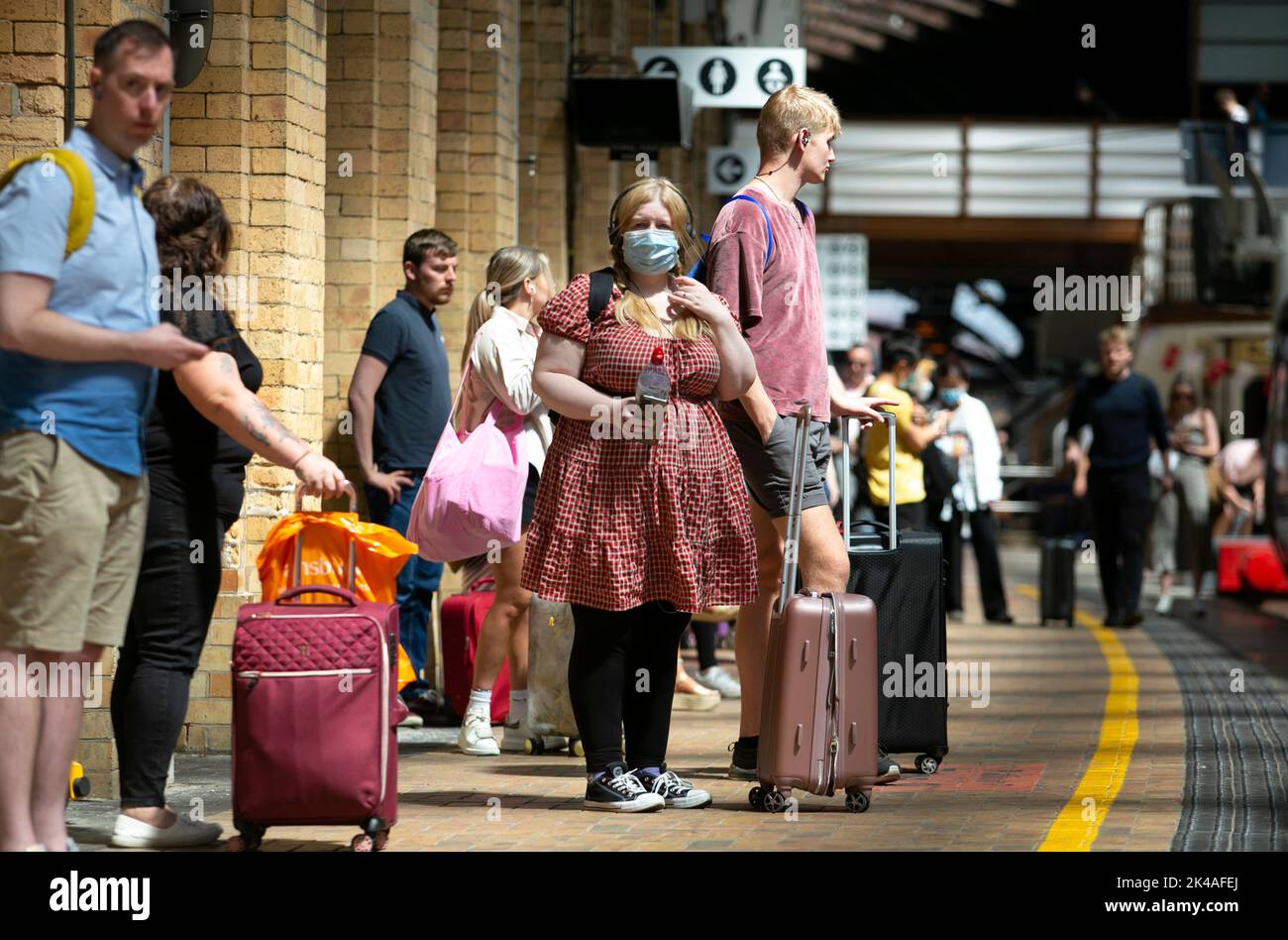 Rail passengers wait for trains at York train station in North Yorkshire as the UK rail strikes continues in June 2022 throughout the country as 40,00 Stock Photo