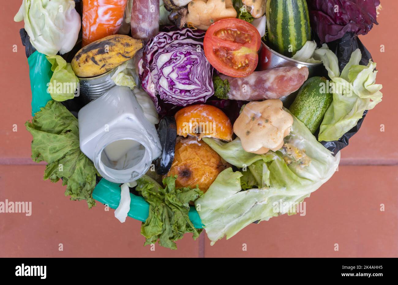 Waste bin with unused food. Food waste as a global problem in the world. Closeup. Isolated on a