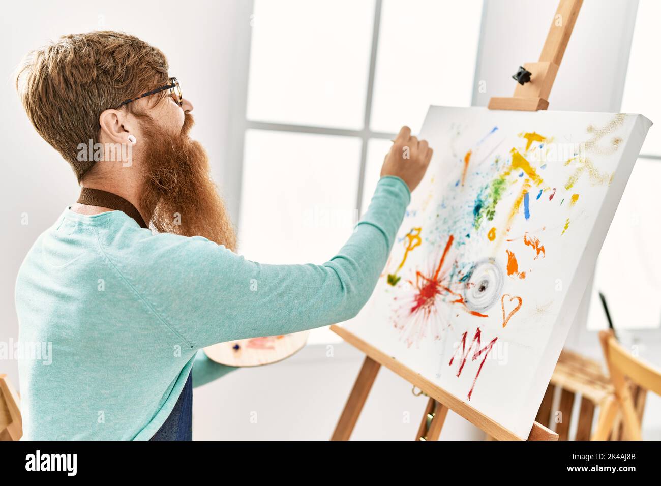 Smiling redhead man painting hi-res stock photography and images - Alamy