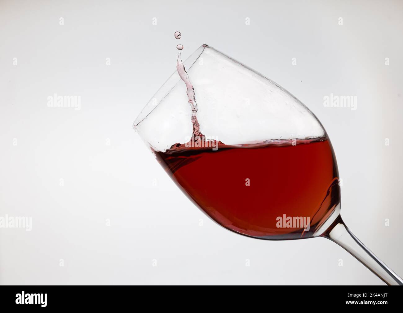 Wine glass with red wine and drops, enjoy Stock Photo