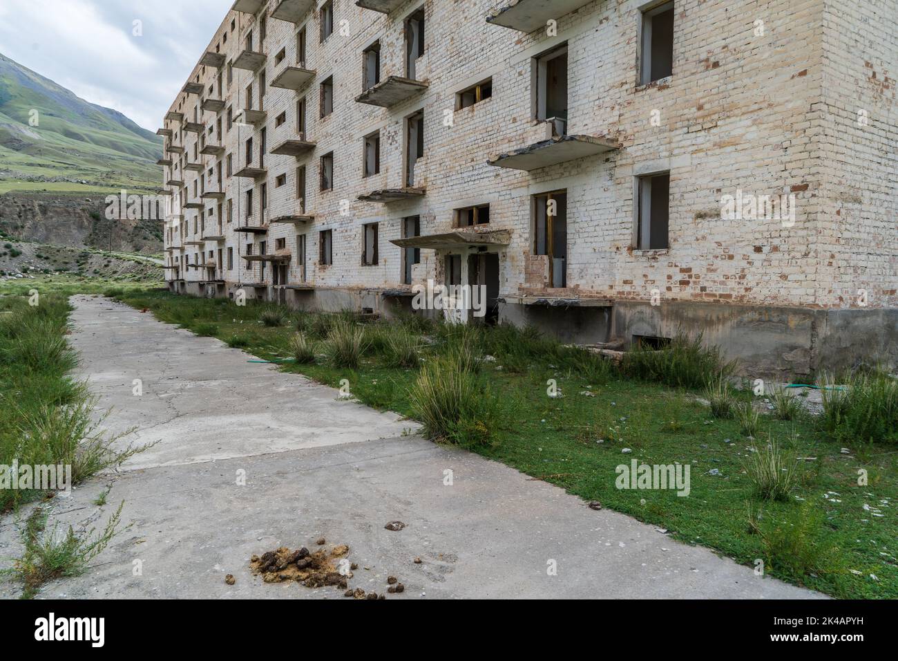 Abandoned and unfinished residential Soviet apartment buildings in Enilchek mining town, Kyrgyzstan Stock Photo