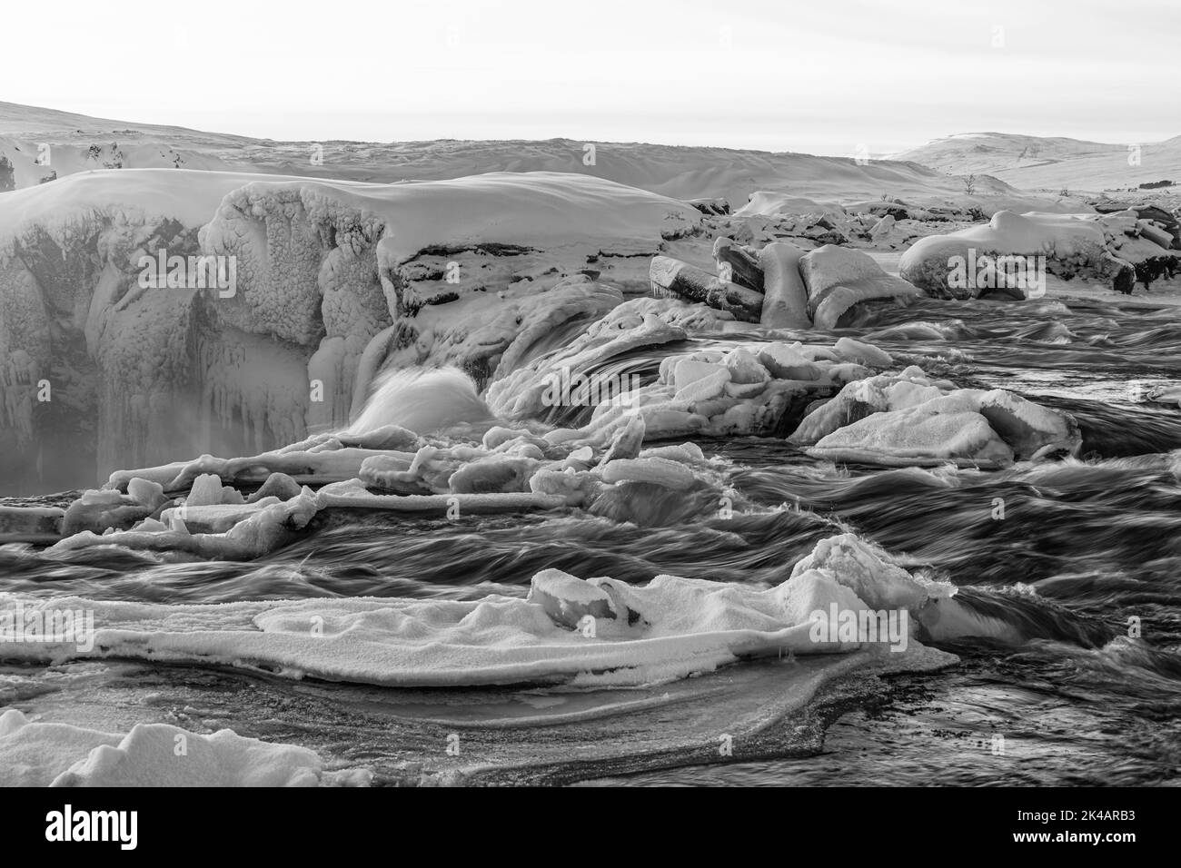 Icefall at the edge of the Godafoss waterfall at dawn, snow-covered landscape, black and white photo, Northern Iceland Eyestra, Iceland Stock Photo