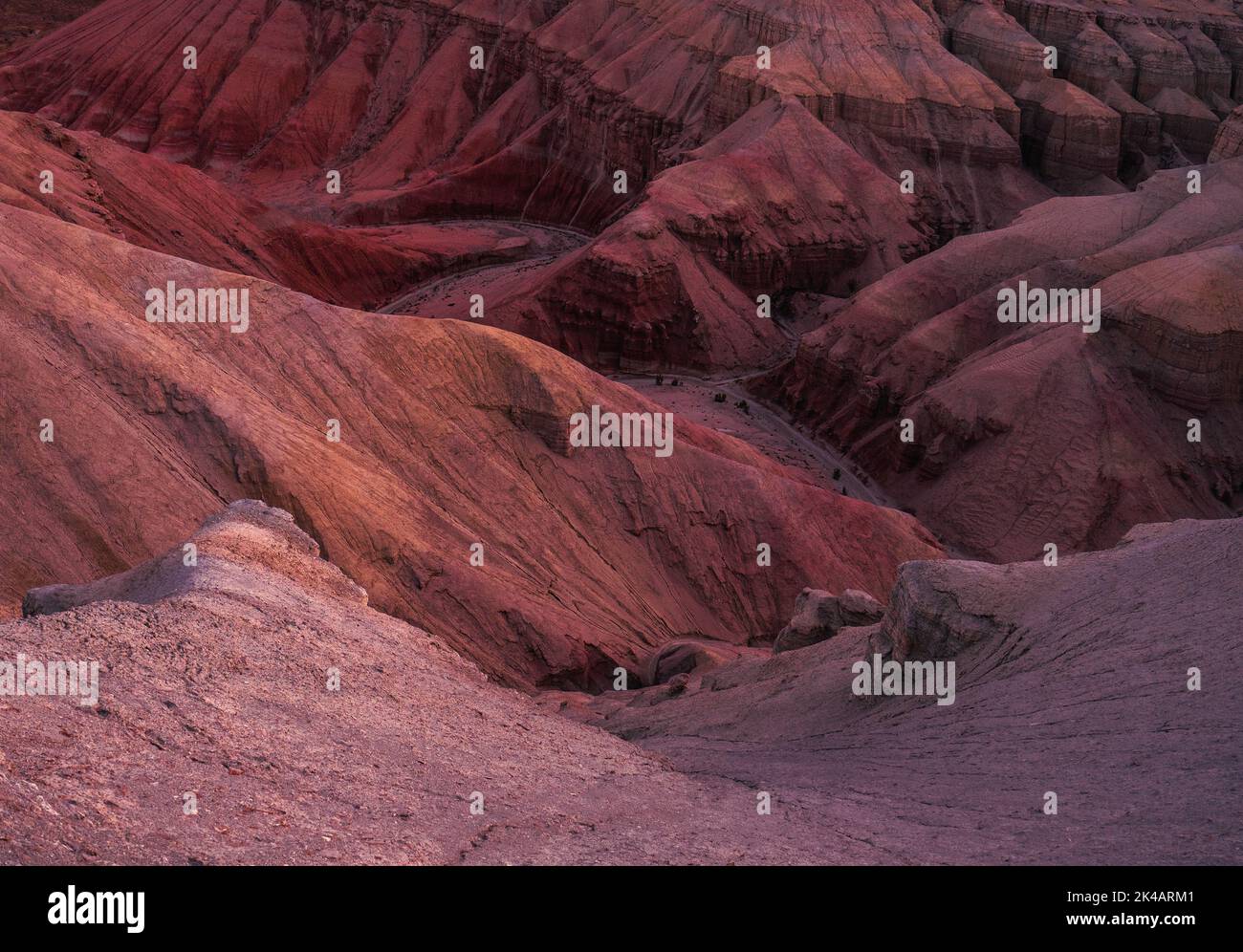 Multicoloured layers of the Aktau Hills at sunrise, Altyn Emel, Kazakhstan Stock Photo