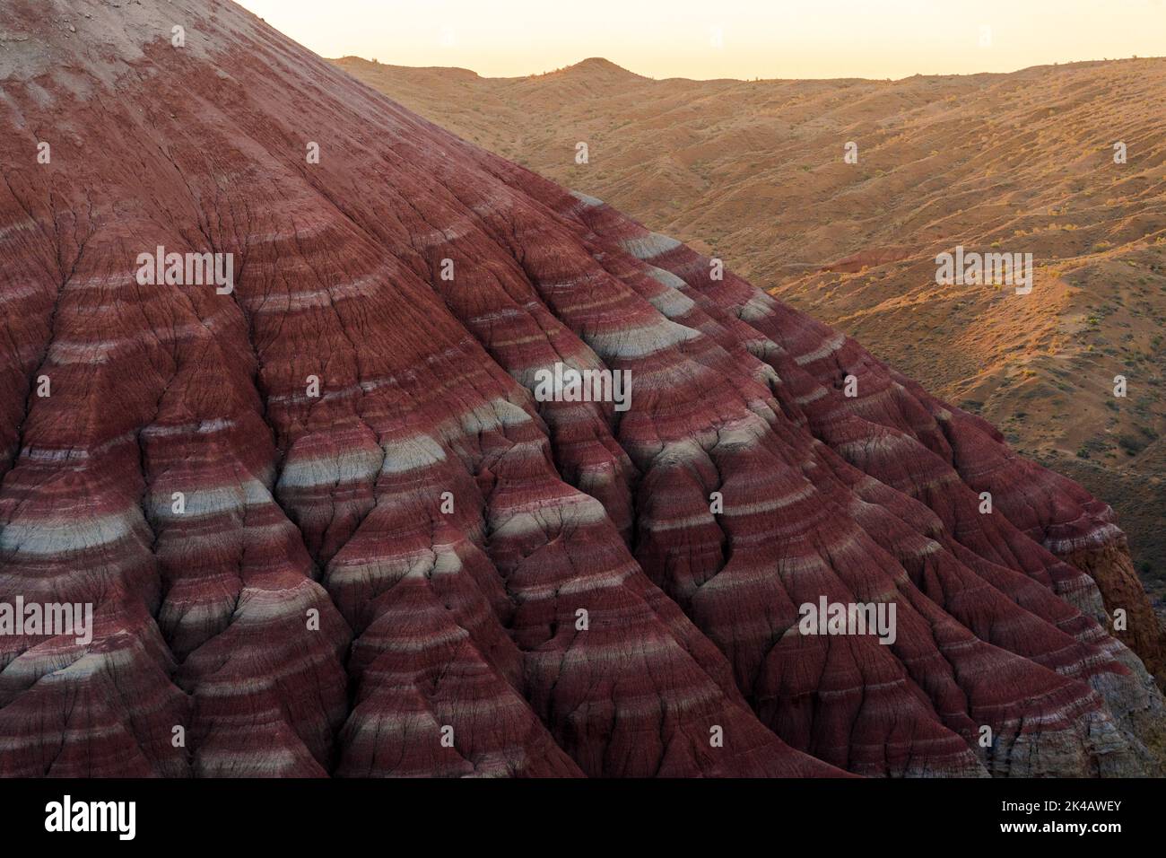 Multicoloured layers of the Aktau Hills at sunrise, Altyn Emel, Kazakhstan Stock Photo