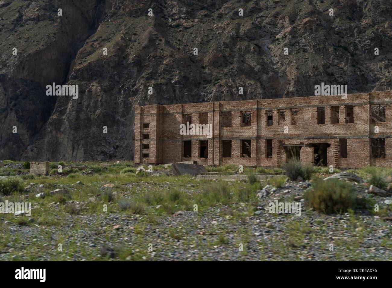 Abandoned and unfinished residential Soviet apartment buildings in Enilchek mining town, Kyrgyzstan Stock Photo