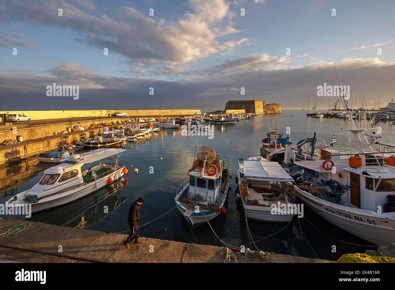 Morning light, super wide angle, fishing boats, harbour wall, Venetian sea fortress, Koules, Morosini, blue sky, grey-white clouds, harbour Stock Photo